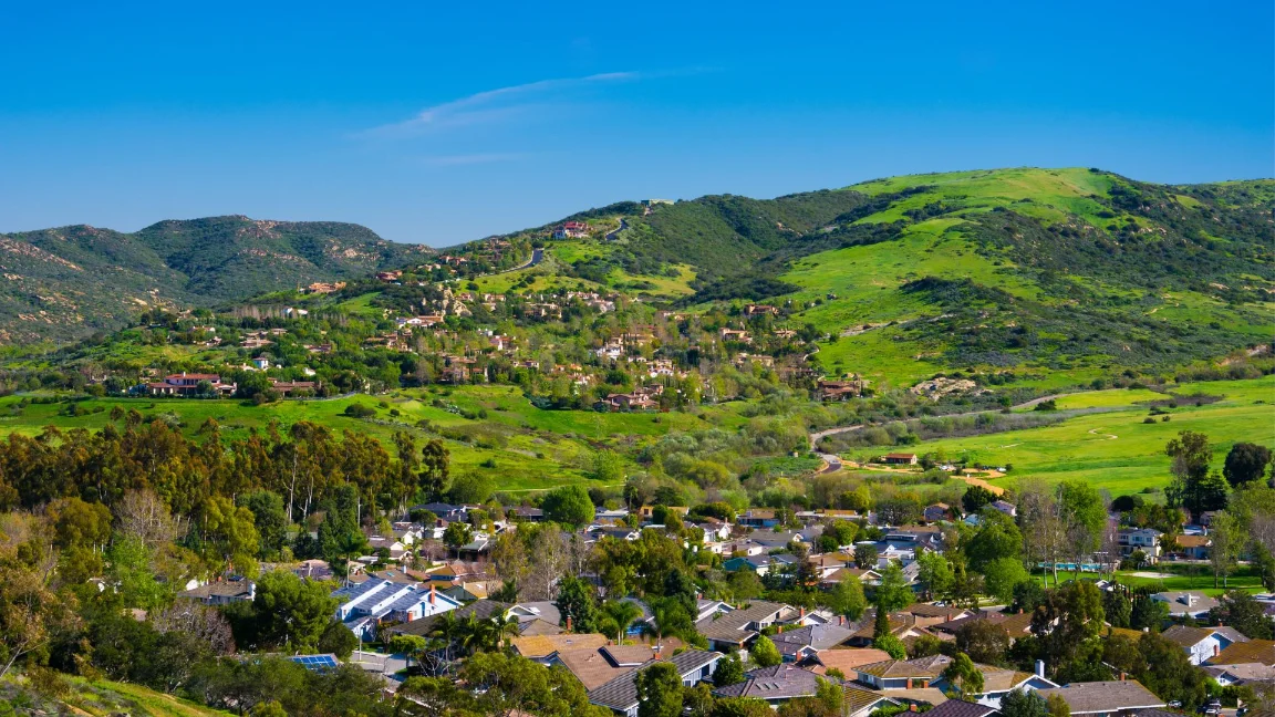Aerial view of the green hills and residential community in Hidden Hills, CA.